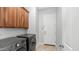 Functional laundry room with modern washer and dryer, ample cabinet storage, and access to the outdoors at 26135 N Desert Mesa Dr, Surprise, AZ 85387