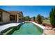Backyard features a refreshing pool and spa with a waterfall feature and a covered patio for outdoor entertaining at 26135 N Desert Mesa Dr, Surprise, AZ 85387