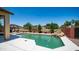 Inviting pool area with a waterfall feature, surrounded by lush landscaping and a spacious patio area with seating at 26135 N Desert Mesa Dr, Surprise, AZ 85387