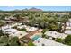 Expansive aerial view showcasing a community pool surrounded by homes with desert landscaping and mountain views at 3032 N 32Nd St # 61, Phoenix, AZ 85018