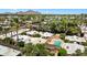 Scenic aerial view of residential neighborhood highlighting lush palm trees, community pool, and desert landscape at 3032 N 32Nd St # 61, Phoenix, AZ 85018
