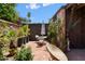 Private back patio with seating surrounded by lush landscaping at 3032 N 32Nd St # 61, Phoenix, AZ 85018