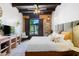 Sunlit bedroom offers stylish decor, exposed beams, and large window overlooking greenery at 3032 N 32Nd St # 61, Phoenix, AZ 85018