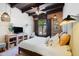 Relaxing bedroom boasts wood beam ceiling, shutters on the window and stylish furnishings at 3032 N 32Nd St # 61, Phoenix, AZ 85018