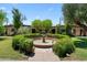 Well-manicured community courtyard with a beautiful fountain and lush greenery at 3032 N 32Nd St # 61, Phoenix, AZ 85018