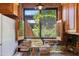 Kitchen window offers a serene view of the lush greenery and staircase at 3032 N 32Nd St # 61, Phoenix, AZ 85018