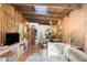 Spacious living room boasts wood beam ceilings, brick accent walls, and seamless flow to dining area at 3032 N 32Nd St # 61, Phoenix, AZ 85018