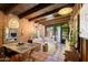 Inviting living room features exposed brick, wood beams, and an abundance of natural light at 3032 N 32Nd St # 61, Phoenix, AZ 85018