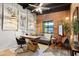 Inviting home office features a brick accent wall, cozy seating area, and natural light at 3032 N 32Nd St # 61, Phoenix, AZ 85018