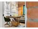 Bright office with wooden desk, exposed brick, and comfortable seating offers a serene workspace at 3032 N 32Nd St # 61, Phoenix, AZ 85018