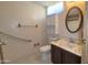 Bathroom with grab bar and a vanity featuring a marble countertop and dark cabinetry at 3104 E Broadway Rd # 268, Mesa, AZ 85204