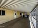 Covered carport area with access doors to the home, window, and storage at 3104 E Broadway Rd # 268, Mesa, AZ 85204
