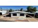 Charming manufactured home with a covered awning, landscaped front yard, and well maintained grounds at 3104 E Broadway Rd # 268, Mesa, AZ 85204
