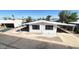 Inviting manufactured home with covered parking and an awning, complemented by well-maintained landscaping at 3104 E Broadway Rd # 268, Mesa, AZ 85204
