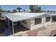 Manufactured home featuring awning, well-maintained exterior, and neatly landscaped yard at 3104 E Broadway Rd # 268, Mesa, AZ 85204