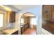 Bright kitchen with wooden cabinetry, laminate countertops, and an archway opening at 3104 E Broadway Rd # 268, Mesa, AZ 85204