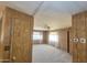 A living room featuring wall paneling and a large window at 3104 E Broadway Rd # 268, Mesa, AZ 85204