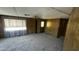 Living room showcasing a large window, ceiling fan, and wood-paneled walls at 3104 E Broadway Rd # 268, Mesa, AZ 85204