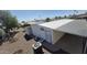 Rear exterior of a well-maintained manufactured home featuring ample parking and storage at 3104 E Broadway Rd # 268, Mesa, AZ 85204