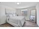 Comfortable bedroom featuring wood floors, natural light, and a decoratively framed mirror at 320 E Mckellips Rd # 25, Mesa, AZ 85201