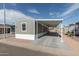 Charming home featuring desert landscaping, a covered parking area, and neutral-colored siding at 320 E Mckellips Rd # 25, Mesa, AZ 85201