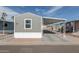 Single-story home featuring desert landscaping, a covered parking area, and neutral-colored siding at 320 E Mckellips Rd # 25, Mesa, AZ 85201