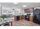 Well-lit kitchen featuring wood cabinets, black appliances, and an open floor plan to the living area at 320 E Mckellips Rd # 25, Mesa, AZ 85201