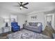 Comfortable living room features a ceiling fan, neutral walls, couch, and a chair at 320 E Mckellips Rd # 25, Mesa, AZ 85201