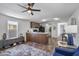 Inviting living room and open kitchen concept with modern decor, ceiling fan, and wood accents at 320 E Mckellips Rd # 25, Mesa, AZ 85201