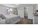 Bright main bedroom with a large window, closet, wood floors, and minimalist decor at 320 E Mckellips Rd # 25, Mesa, AZ 85201