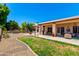 Sprawling backyard with covered patio, grassy area, and desert landscaping at 3535 E Brookwood Ct, Phoenix, AZ 85048