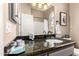 Bathroom with sleek granite countertop, modern faucet, and decorative accents at 3535 E Brookwood Ct, Phoenix, AZ 85048