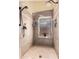Tiled shower features rainfall shower head, frosted window, and soap/shampoo niche at 3535 E Brookwood Ct, Phoenix, AZ 85048