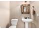 Small bathroom features a pedestal sink, ornate mirror, and neutral color palette at 3535 E Brookwood Ct, Phoenix, AZ 85048