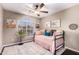 Light-filled bedroom features a daybed, colorful pillows and neutral rug and decor at 3535 E Brookwood Ct, Phoenix, AZ 85048