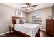 Bedroom featuring ceiling fan, standard closet, and bright window with neighborhood views at 3535 E Brookwood Ct, Phoenix, AZ 85048