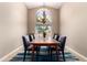 Elegant dining room with a chandelier, a large window, and seating for six at 3535 E Brookwood Ct, Phoenix, AZ 85048
