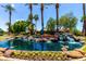 Lakewood entrance with waterfall feature, lush landscaping, and decorative statue at 3535 E Brookwood Ct, Phoenix, AZ 85048