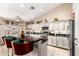 Bright and airy kitchen featuring white cabinets, a breakfast bar, and stainless steel appliances at 3535 E Brookwood Ct, Phoenix, AZ 85048