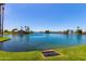 Lake view with fountain feature surrounded by lush greenery and waterfront homes at 3535 E Brookwood Ct, Phoenix, AZ 85048