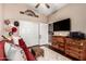 Living room with a ceiling fan, sitting area, TV, closet, and hardwood floors at 3535 E Brookwood Ct, Phoenix, AZ 85048
