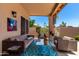 Covered patio with comfortable seating, outdoor decor, and a view of the backyard at 3535 E Brookwood Ct, Phoenix, AZ 85048
