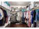 Walk-in closet featuring custom storage, shelving, and shoe organizers with dark wood flooring at 3535 E Brookwood Ct, Phoenix, AZ 85048