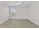 Brightly lit bedroom with neutral carpet, ceiling fan, and large window at 3575 E Gary Way, Gilbert, AZ 85234