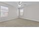 Bedroom with neutral carpet, ceiling fan, and well-lit by dual windows at 3575 E Gary Way, Gilbert, AZ 85234