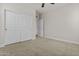 This is a bright bedroom with neutral carpet and features large, white closet doors at 3575 E Gary Way, Gilbert, AZ 85234