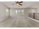 A spacious bonus room with neutral walls and carpet offers plenty of natural light at 3575 E Gary Way, Gilbert, AZ 85234