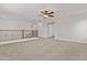 This is a bonus room featuring neutral walls, neutral carpet, and a wooden railing at 3575 E Gary Way, Gilbert, AZ 85234