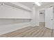 Spacious walk-in closet with laminate floors, hanging racks, and access to another room at 3575 E Gary Way, Gilbert, AZ 85234