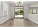 Bright dining room featuring wood-look floors, a modern light fixture, and sliding doors to the backyard at 3575 E Gary Way, Gilbert, AZ 85234